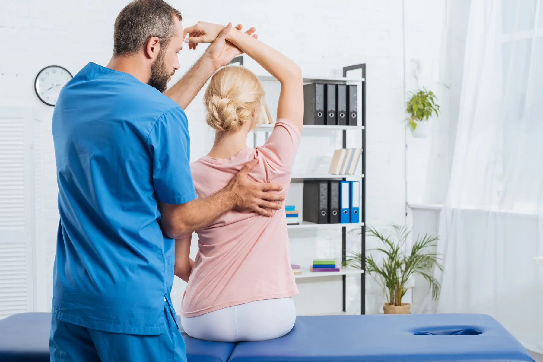 Masseur giving a massage to a young woman
